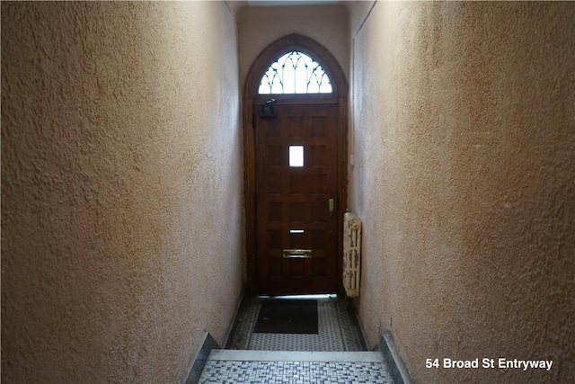 doorway featuring dark tile patterned floors