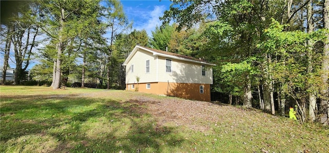 view of side of home featuring a lawn