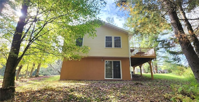 rear view of property with a wooden deck