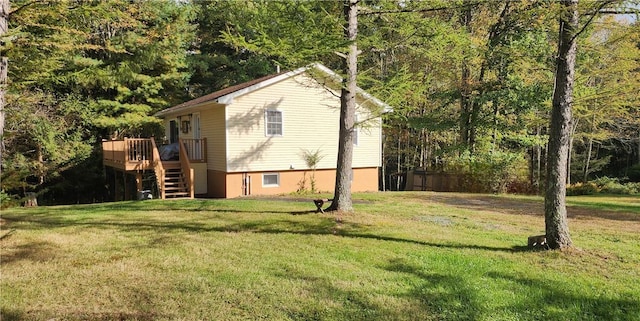 view of side of home featuring a deck and a yard