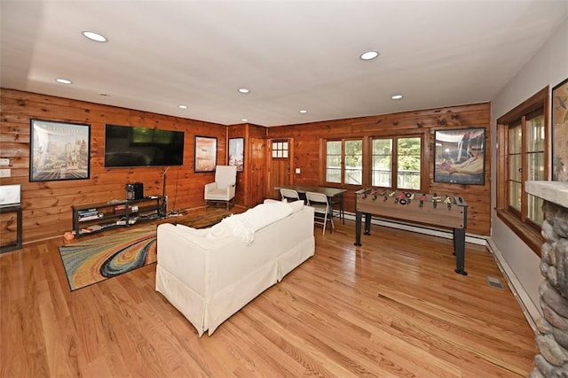 living room featuring wood walls and light wood-type flooring