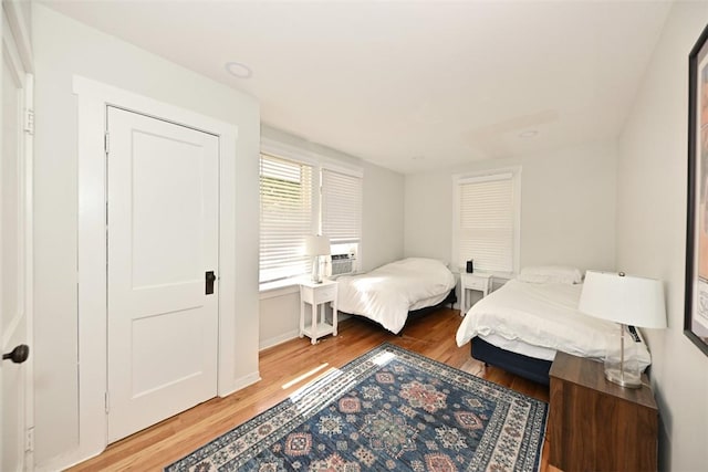 bedroom featuring cooling unit and hardwood / wood-style flooring