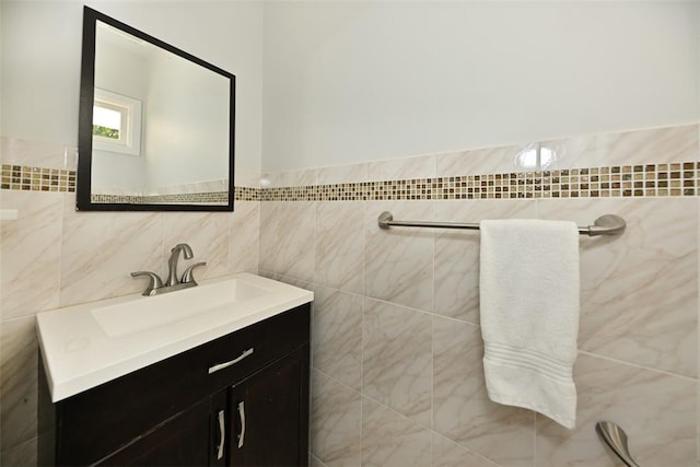 bathroom with vanity and tile walls