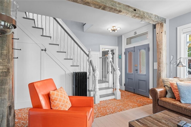 entrance foyer with wood-type flooring and radiator heating unit