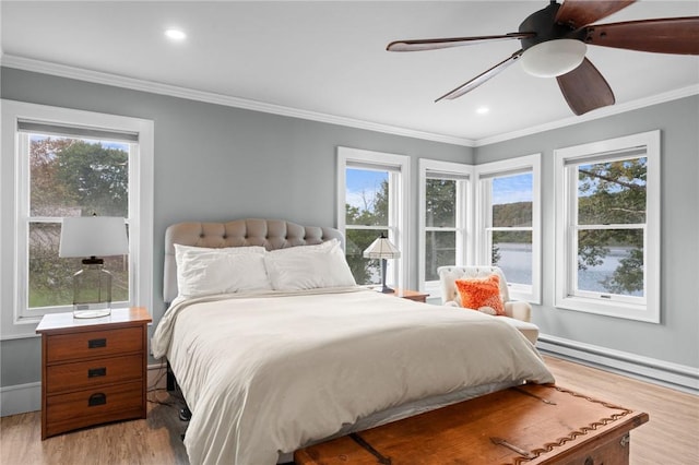 bedroom with light wood-type flooring, multiple windows, and ceiling fan