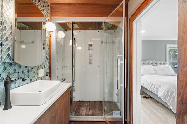 bathroom featuring vanity, hardwood / wood-style flooring, and crown molding