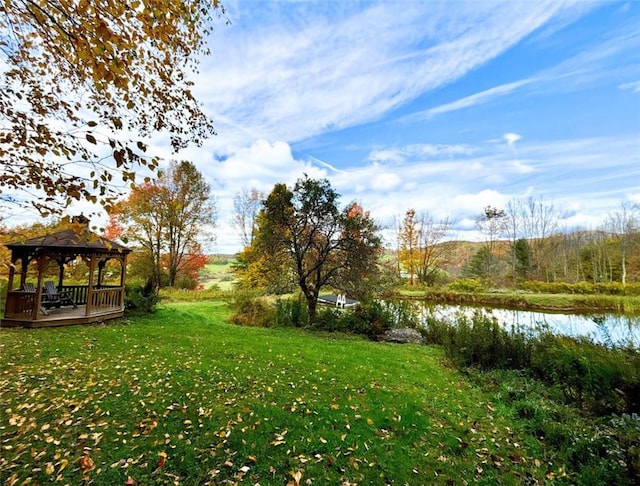 view of yard featuring a gazebo and a water view