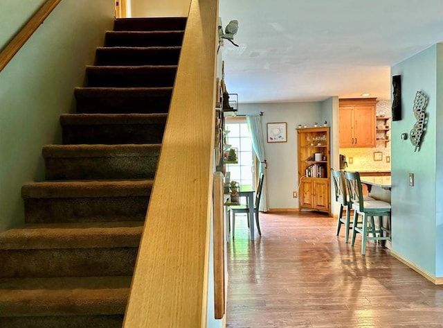 staircase featuring hardwood / wood-style floors