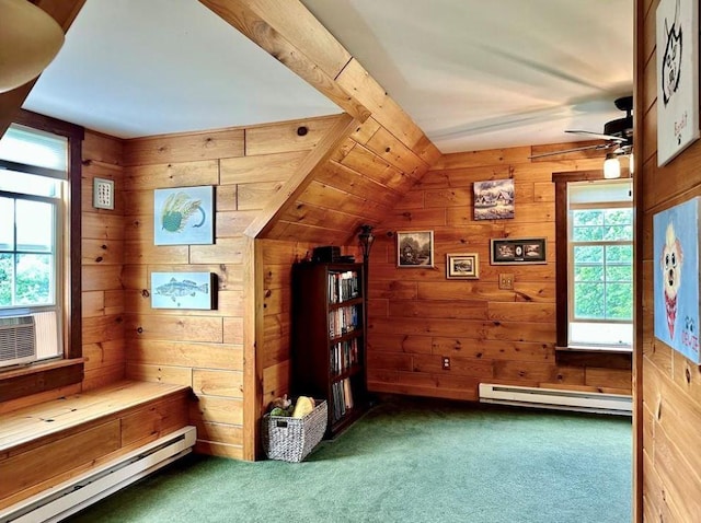 interior space featuring vaulted ceiling, baseboard heating, and wood walls