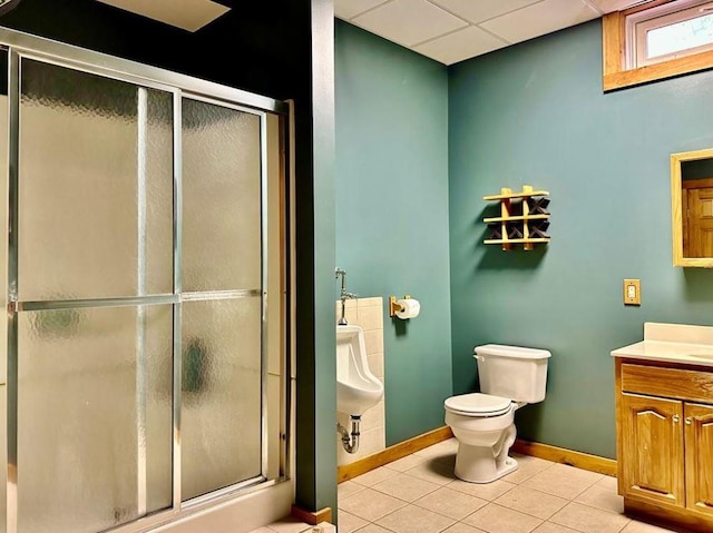 bathroom with walk in shower, vanity, tile patterned floors, and a drop ceiling