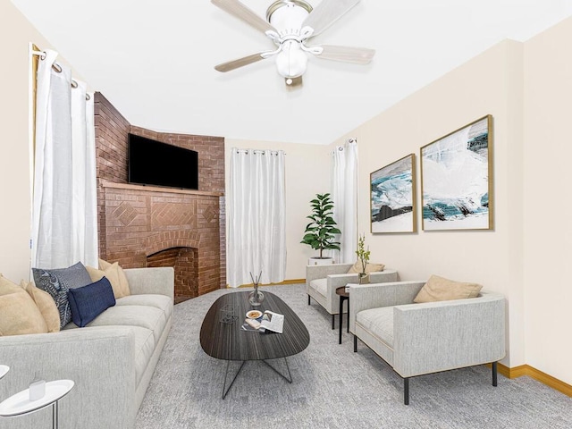 living room with ceiling fan, carpet, and a brick fireplace