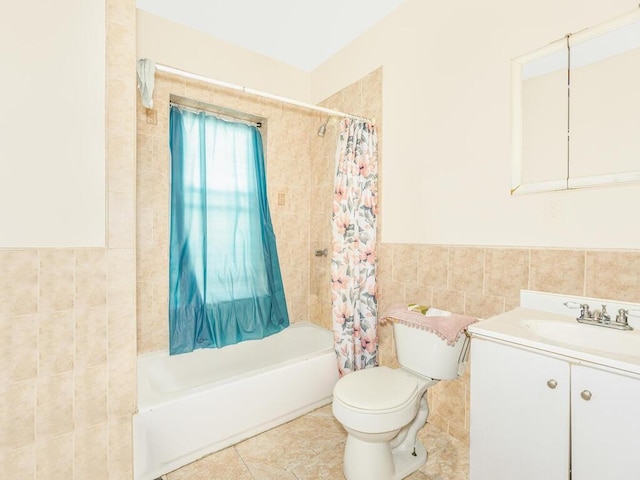 full bathroom featuring vanity, toilet, tile walls, and shower / tub combo