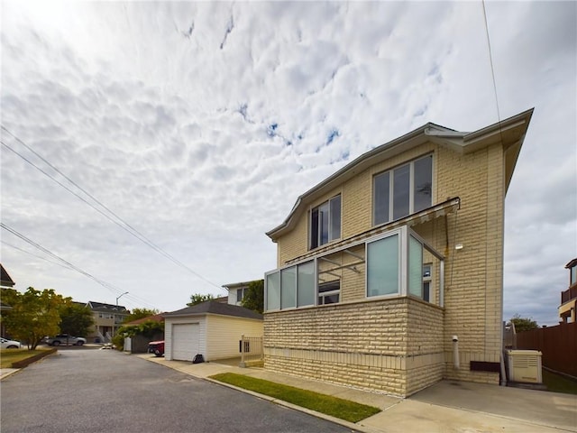 view of home's exterior featuring an outbuilding and a garage