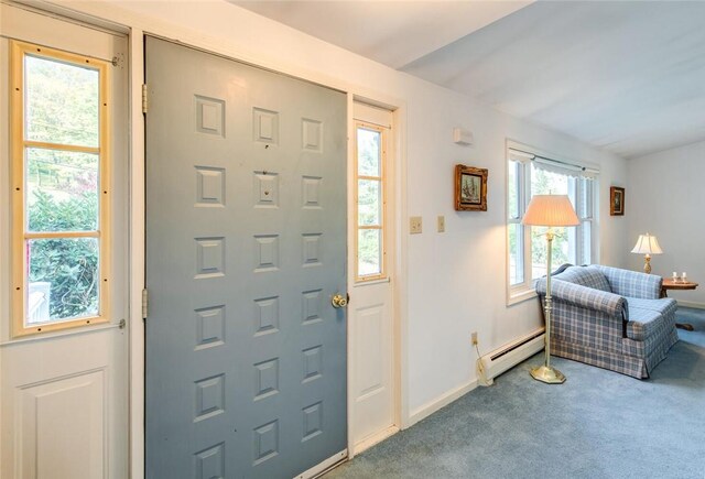 foyer with carpet floors and baseboard heating