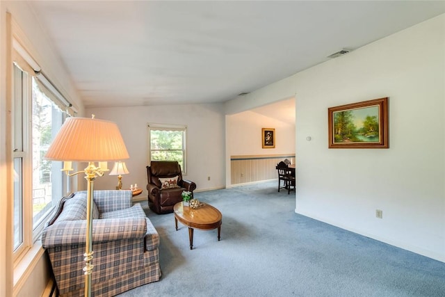 sitting room featuring carpet, a healthy amount of sunlight, and lofted ceiling