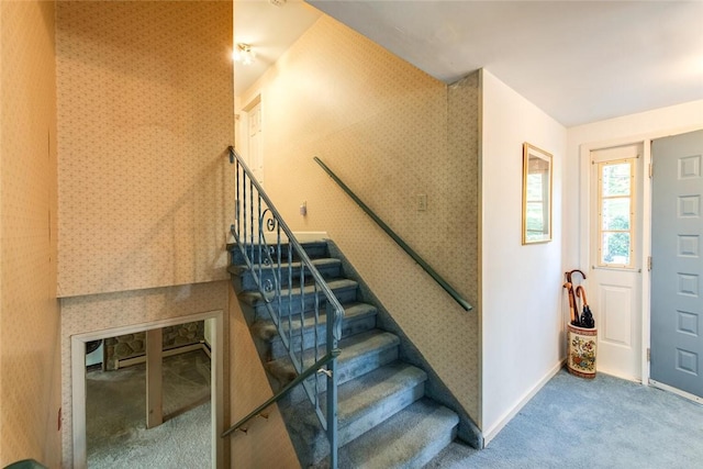 foyer entrance with carpet flooring