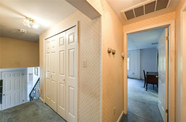 hallway with dark colored carpet