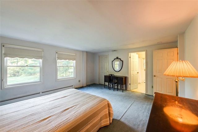 bedroom with light carpet and baseboard heating