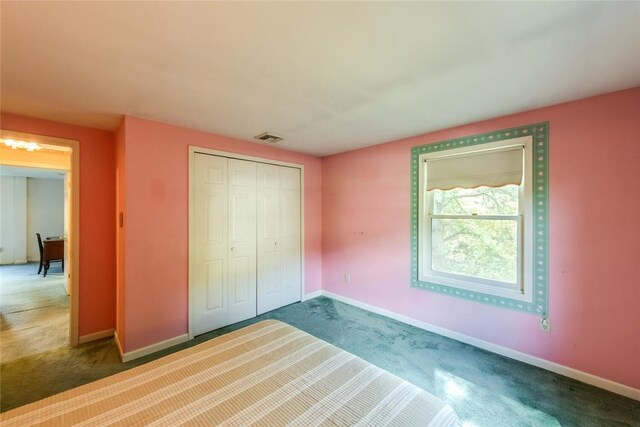 unfurnished bedroom with carpet floors and a closet