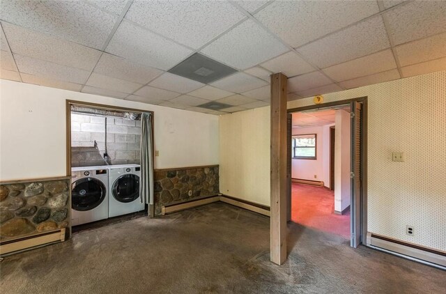 laundry room featuring washer and dryer, a baseboard radiator, and dark carpet