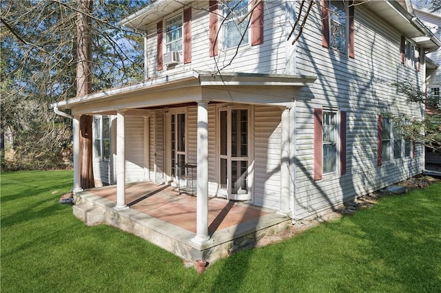 rear view of property featuring a yard and cooling unit