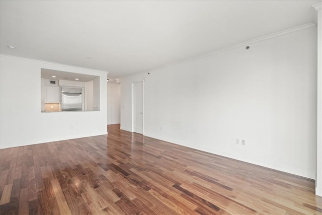 unfurnished room featuring hardwood / wood-style flooring and crown molding