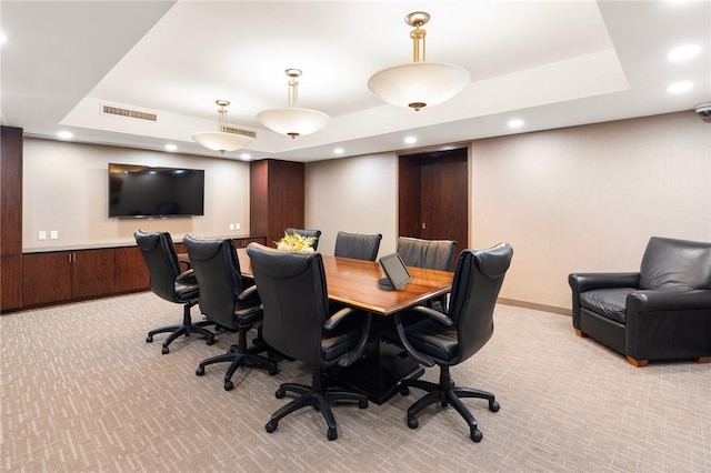 home office with light colored carpet, wooden walls, and a tray ceiling