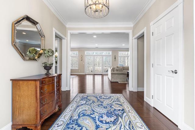 interior space with ornamental molding, dark hardwood / wood-style floors, and a chandelier