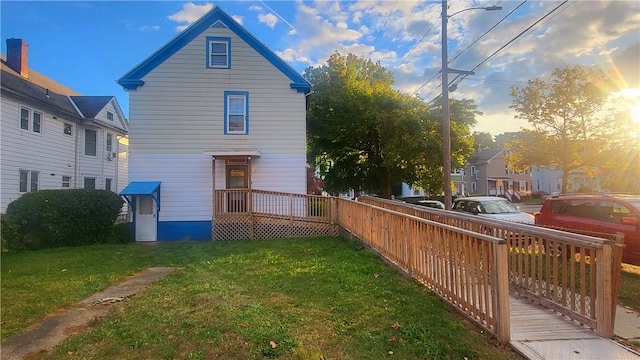 back house at dusk with a yard