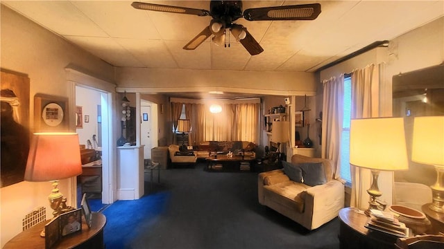 living room featuring ceiling fan and a wealth of natural light