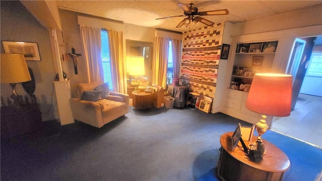 living area featuring ceiling fan and a wealth of natural light