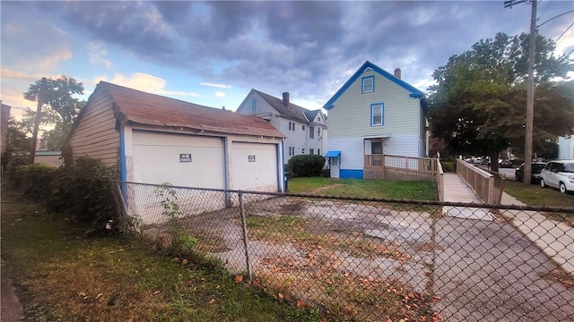 view of side of home featuring a garage and an outdoor structure