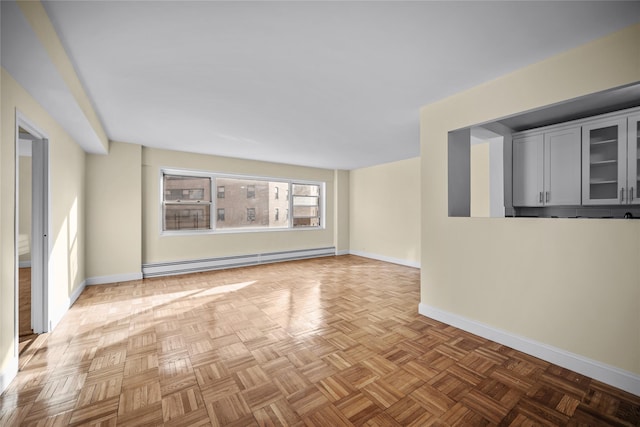 spare room with light parquet flooring and a baseboard heating unit