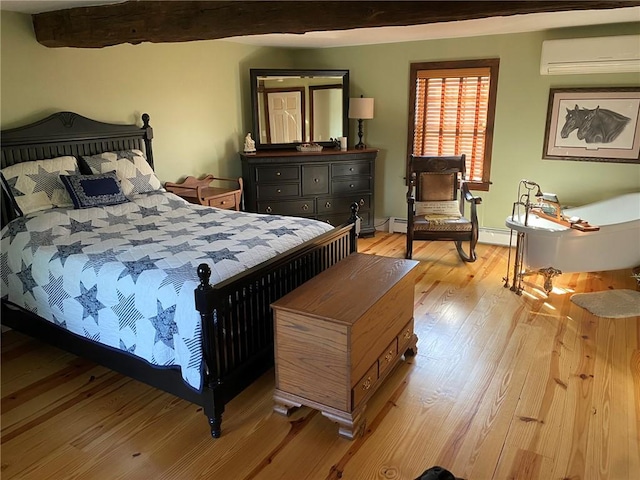 bedroom featuring beam ceiling, light hardwood / wood-style floors, an AC wall unit, and baseboard heating