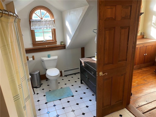 bathroom featuring vanity, a baseboard radiator, toilet, and vaulted ceiling