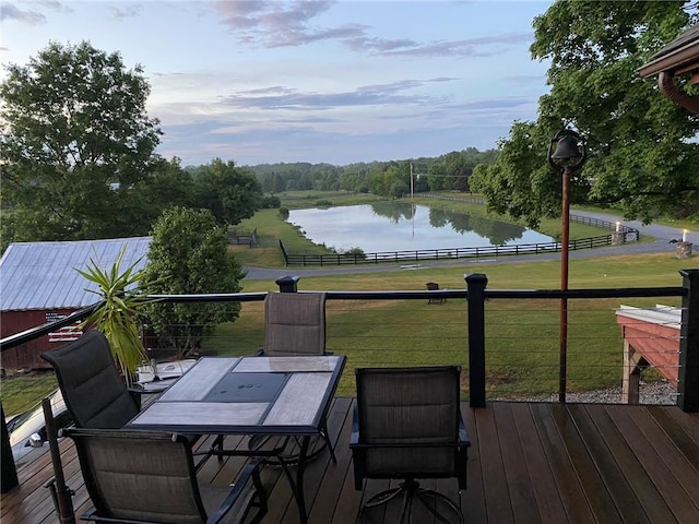 wooden terrace with a lawn and a water view