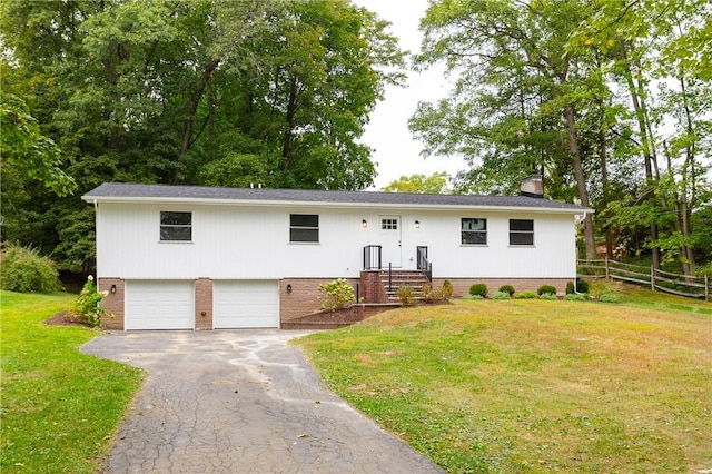 raised ranch with a garage and a front lawn