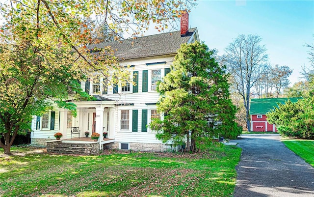 colonial-style house with a front lawn