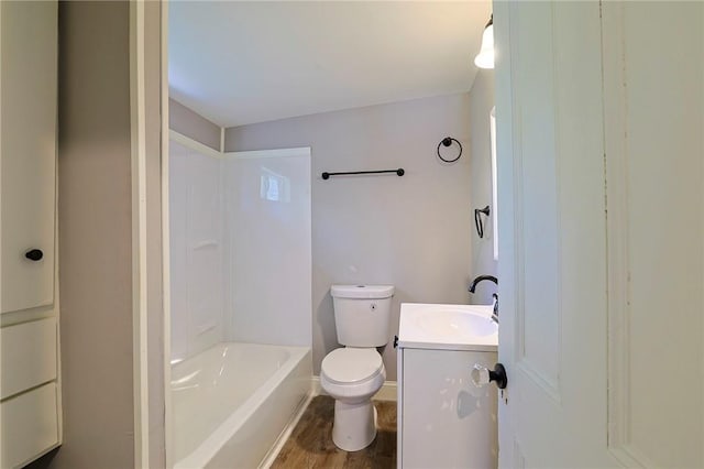 full bathroom with hardwood / wood-style floors, vanity, toilet, and bathtub / shower combination