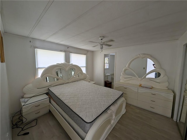 bedroom with ceiling fan and wood-type flooring