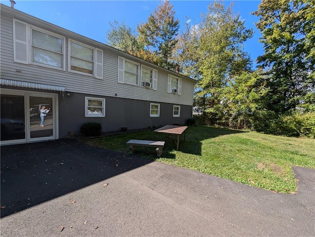 view of side of property with a yard