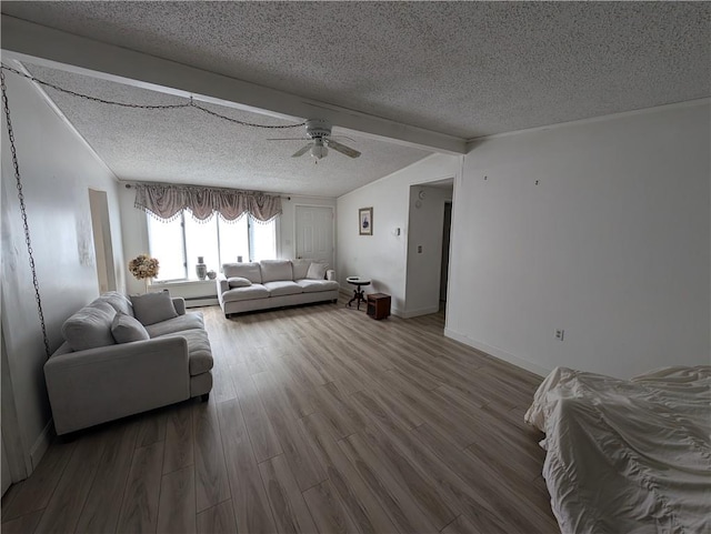 living room featuring hardwood / wood-style flooring, ceiling fan, a textured ceiling, and beamed ceiling