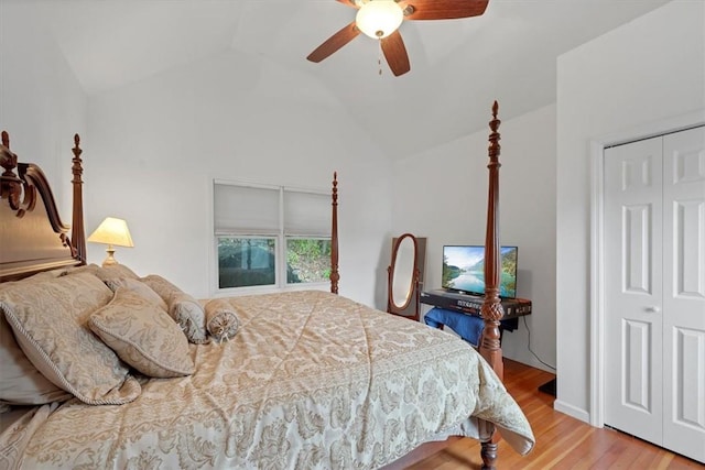 bedroom featuring light wood-type flooring, a closet, ceiling fan, and lofted ceiling