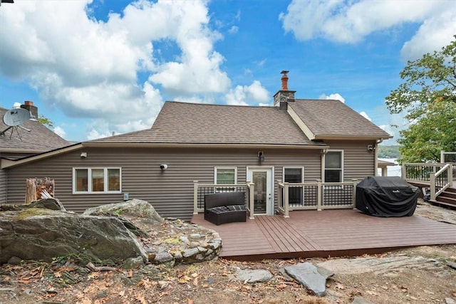 rear view of house with a wooden deck