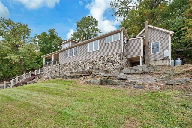 rear view of house with a yard