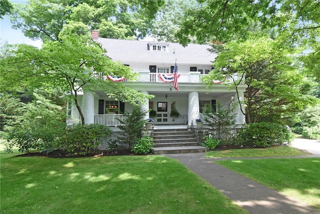 view of front of home with covered porch and a front yard