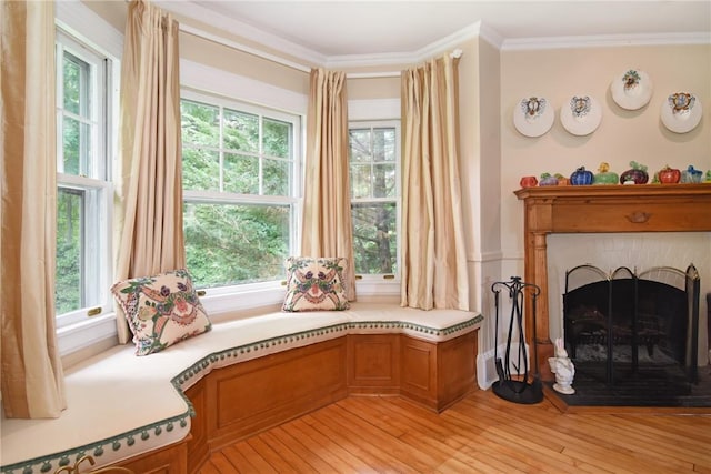 sitting room featuring light wood-type flooring and ornamental molding