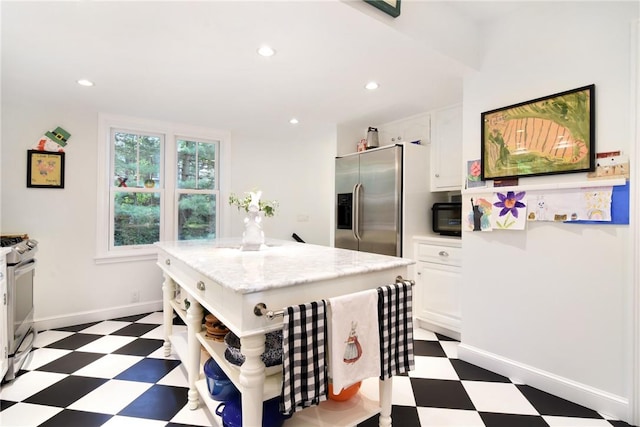 kitchen featuring a center island, white cabinets, and appliances with stainless steel finishes