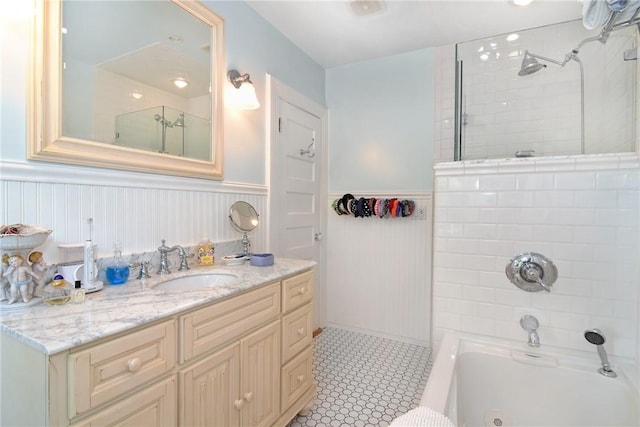 bathroom with tiled shower / bath combo and vanity