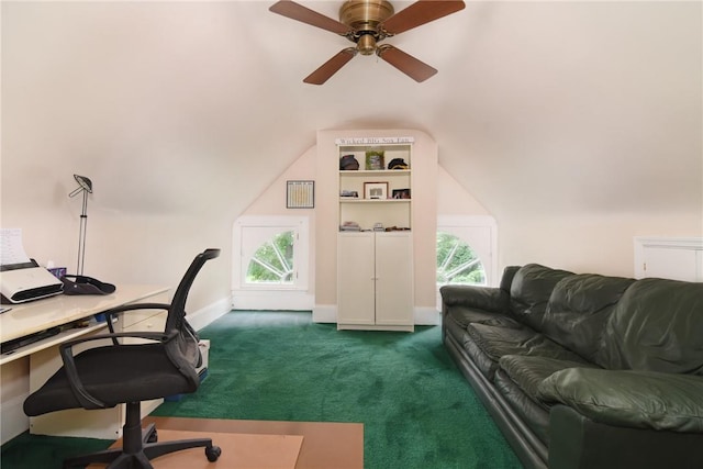 office area with dark colored carpet, vaulted ceiling, plenty of natural light, and ceiling fan